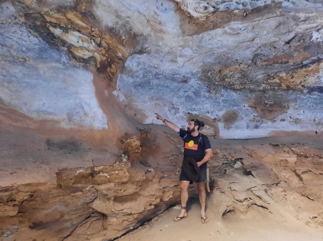 Guide pointing out rock art